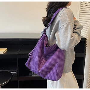 Close-up of purple plaid oxford cloth texture and wide strap on large tote bag