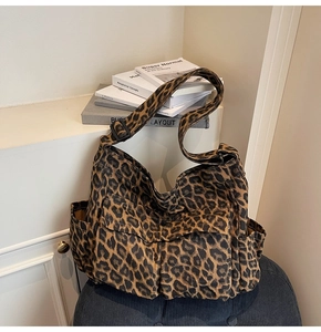 Detail view of large leopard canvas tote bag showing side pocket and durable fabric
