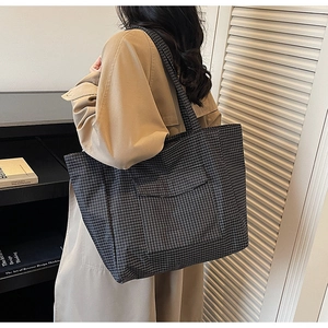 Detail of grey plaid oxford tote bag with front pocket and shoulder strap for commuting