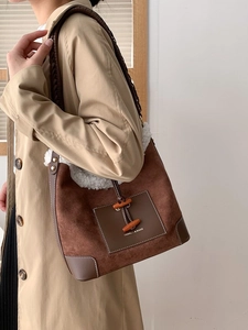 Retro brown suede dumpling bag with faux shearling trim and decorative horn button