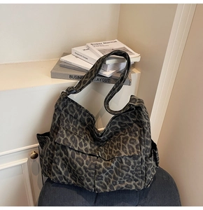 Detailed macro view of leopard print canvas bag featuring side pockets and durable texture