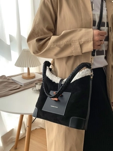 Chic black plush dumpling bag with lamb wool trim and woven leather handle for women