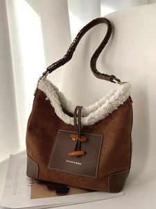 Brown suede dumpling bag with white faux shearling trim and stylish wooden toggle buttons