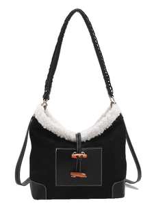 Chic black plush dumpling shoulder bag with contrast fleece trim and horn button closure