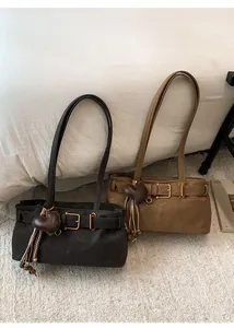 Detail of matte retro shoulder bags with heart pendants and adjustable buckle straps