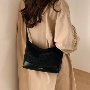 Detail of black crossbody bag with mixed suede and smooth leather texture finish
