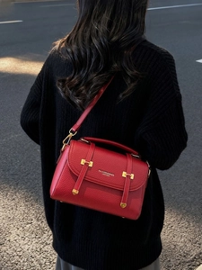 Red lychee pattern leather crossbody satchel bag shown from back view on model