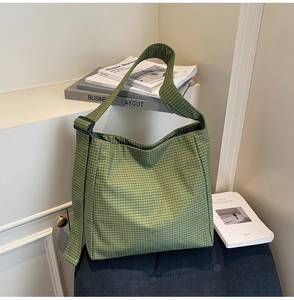 Detail of green and white plaid oxford fabric texture and adjustable wide shoulder strap