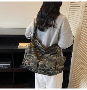 Detailed back view of a camouflage canvas tote bag with adjustable shoulder strap