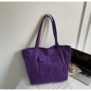 Close-up of purple checkered tote bag featuring front flap pocket and large capacity