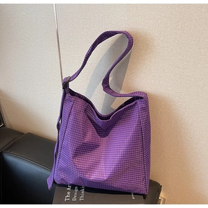 Detail shot of purple plaid oxford fabric and wide shoulder strap on tote bag