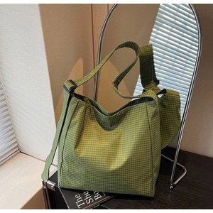 Detail of green plaid oxford tote bag showing soft fabric texture and adjustable strap