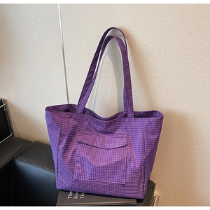 Close-up of purple checkered tote bag with a front flap pocket for daily commute use