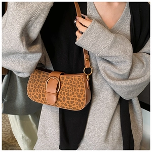 Detail of trendy leopard print shoulder bag with gold round buckle and adjustable strap
