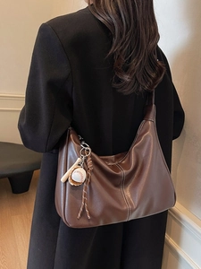 Retro dark brown leather shoulder bag with white contrast stitching and baseball charm