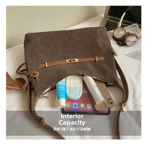 Macro shot of spacious inner capacity showing iPad and makeup inside a dark brown tote