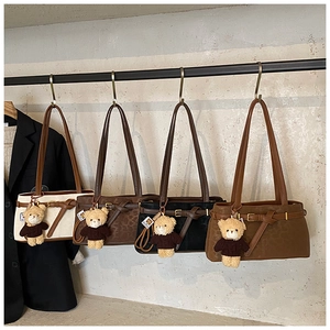 Detail of four leopard print and solid bucket bags with cute teddy bear charms