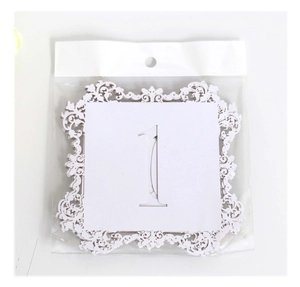 Lace hollow table number card featuring laser cut white paper number one for wedding seating