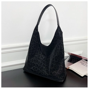 Detail of large black leopard print tote bag in soft suede fabric for office use