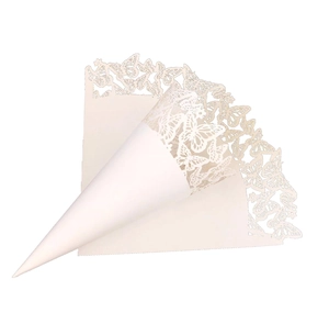Macro view of laser-cut butterfly hollow patterns on ivory white paper wedding cones