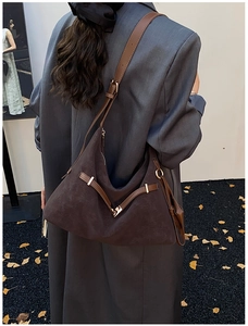 Detail of dark brown matte tote bag showing suede texture and adjustable leather strap