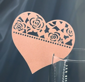 Laser cut heart place card with rose floral design on elegant blue velvet background