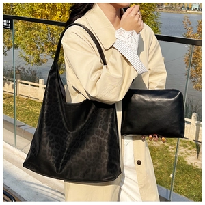 Detail of leopard print tote bag and matching inner pouch shown in outdoor setting