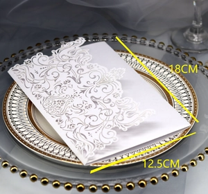 Detail of laser-cut white invitation card with floral patterns, size 18cm x 12.5cm