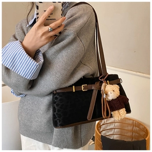 Retro leopard print shoulder bag detail featuring a cute bear pendant charm decoration