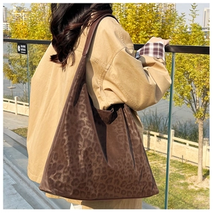 Macro detail of the leopard print hobo bag showing the matte suede texture and pattern