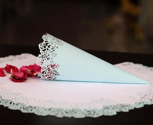 Detailed laser-cut mint blue paper cones with elegant lace edges for wedding petals