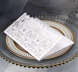 Detailed laser-cut floral pattern and lace design on premium white wedding invitation
