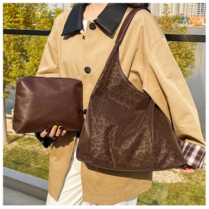 Detail of leopard print tote bag with matching inner pouch for fall fashion styling