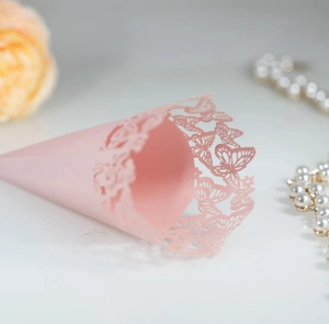 Detailed view of pink laser-cut wedding flower petal cones with delicate butterfly lace