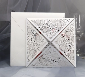 Elegant laser-cut mandala wedding invitation set with white envelope and floral design