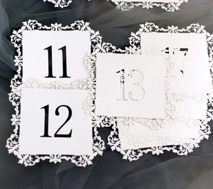 Detailed laser-cut white table numbers 11-17 with elegant European lace hollow patterns