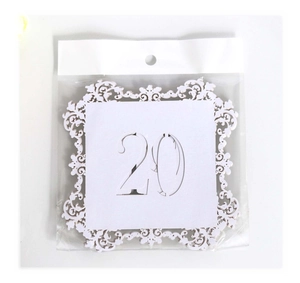 Laser cut white table number card featuring number 20 with ornate lace patterns