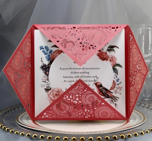 Detail of laser-cut wedding invitation with red floral sleeve and watercolor inner card