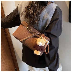 Leopard print bucket bag with cute bear charm shown on model in a retro fashion style