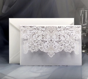 Elegant laser cut pearl white wedding invitation cards with floral hollow pattern and envelopes