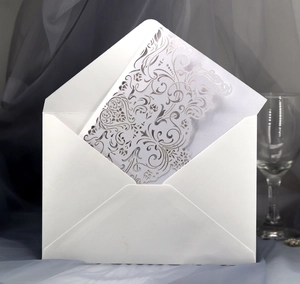 Elegant white laser-cut invitation card and envelope set for weddings and formal events