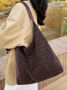 Retro leopard print oversized hobo tote bag for women shown in an outdoor street setting