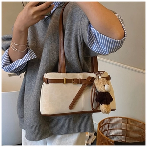Mirror selfie showing the off-white shoulder bag with brown straps and cute bear charm