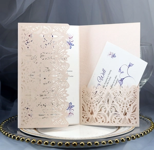 Detail of laser-cut floral wedding invitation with purple flower inner card