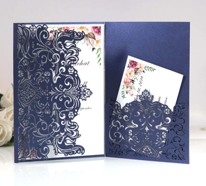 Laser cut navy blue wedding invitation with elegant floral cards and white rose background
