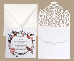 Elegant laser cut wedding invitation set with floral card and white envelopes