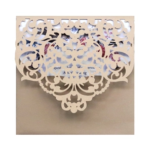 Elegant laser-cut floral wedding invitation set with champagne gold pearlized envelope