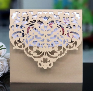 Laser-cut wedding invitation featuring intricate floral patterns on kraft paper cover