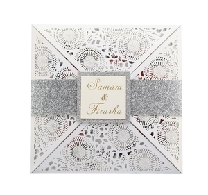 Elegant laser-cut floral wedding invitation with silver glitter band and custom name tag
