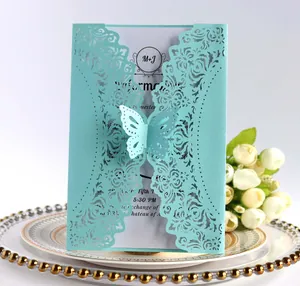 Detailed laser-cut Tiffany Blue wedding invitation with butterfly buckle and white lace inlay